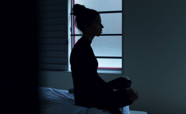 silhouette of a girl in a gloomy room