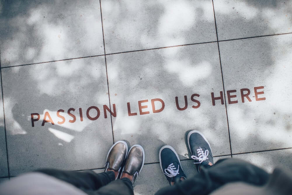 concrete floor with paint saying 'passion led us here'