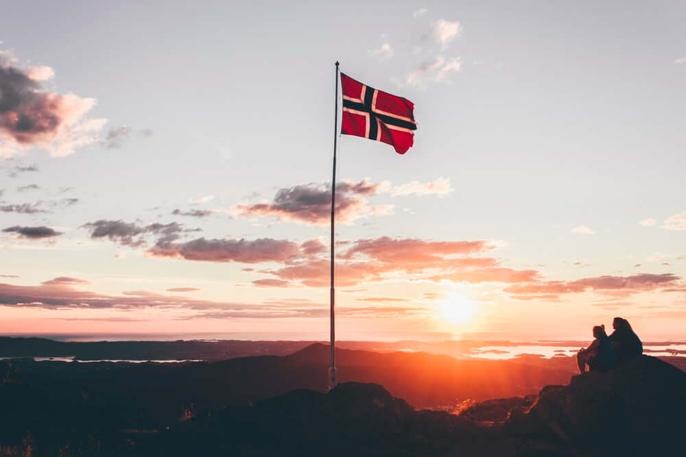 Norwegian flag waving in the sunset.