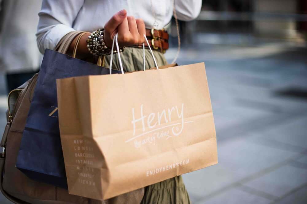 woman holding paper shopping bags