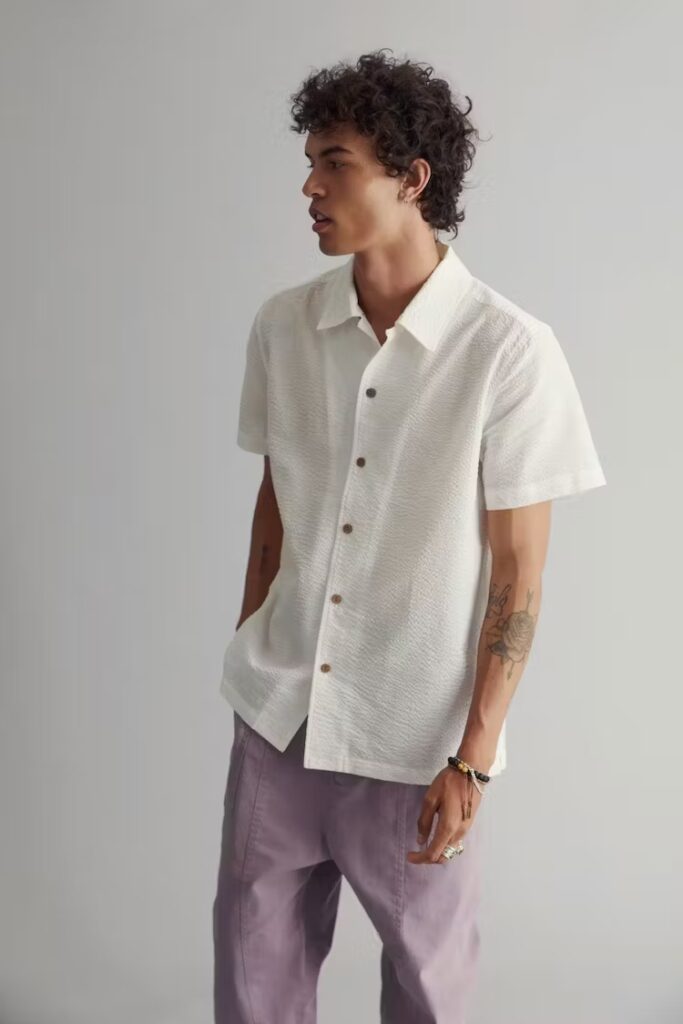 Model wearing short sleeve shirt aned purple chinos