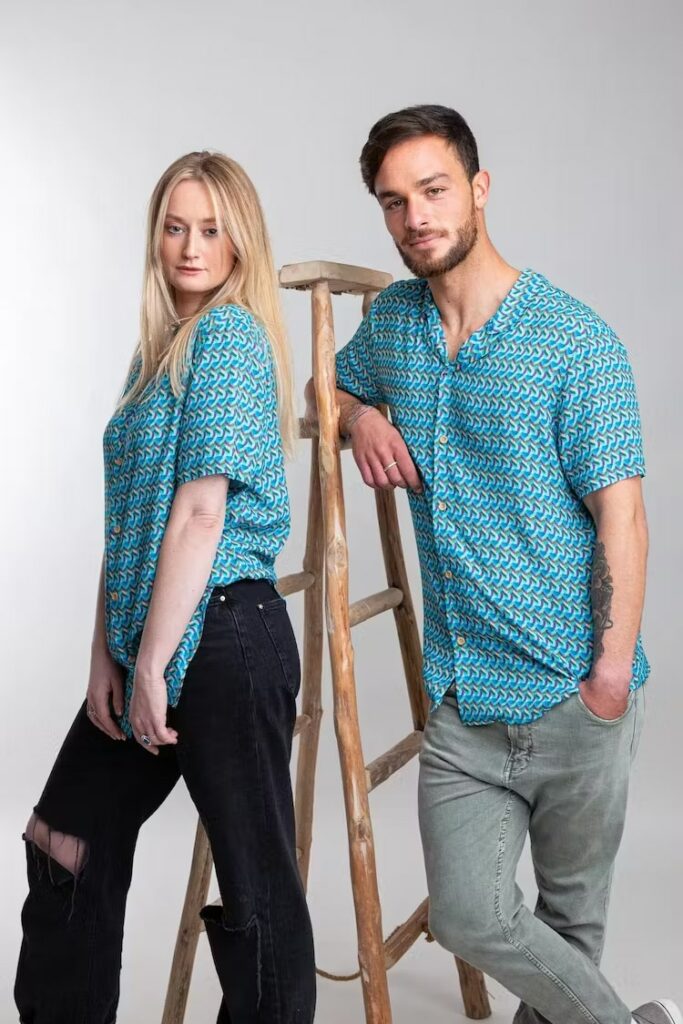 Man and woman wearing bright blue shirts and jeans
